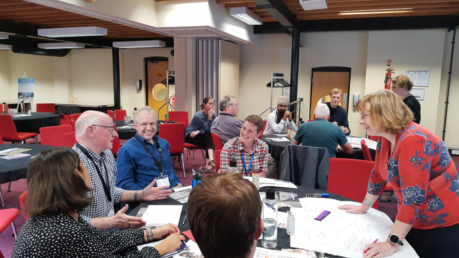 Attendees at a conference sat around a round table during a workshop