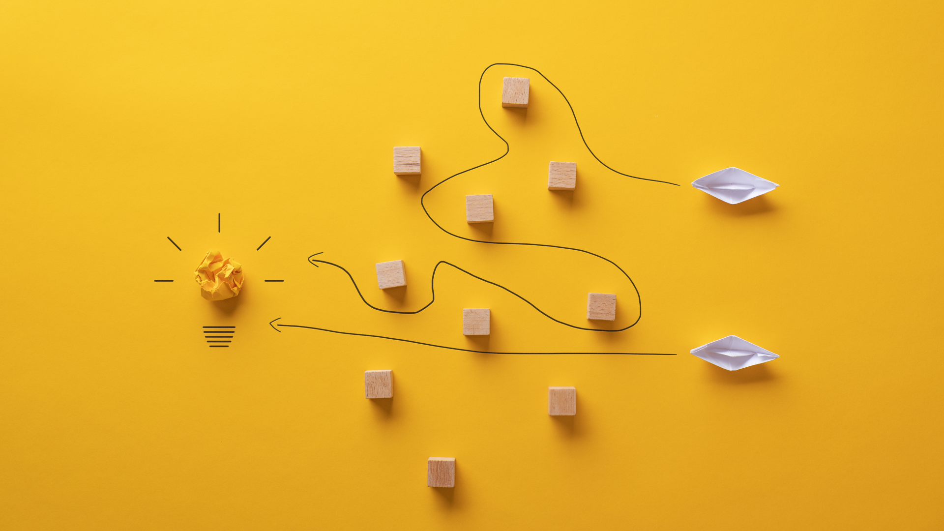 A conceptual image of 2 routes towards a lightbulb - one straightforward and one with square obstacles in the way, a line indicating a more convoluted path