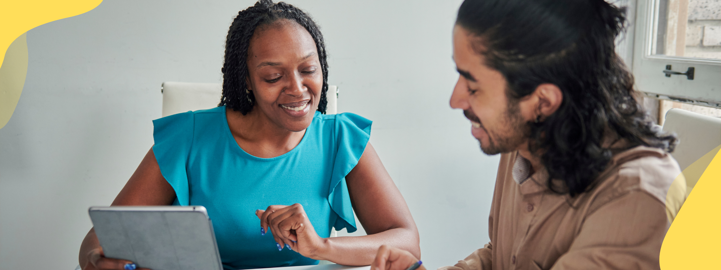 two people sitting at a desk having a conversation