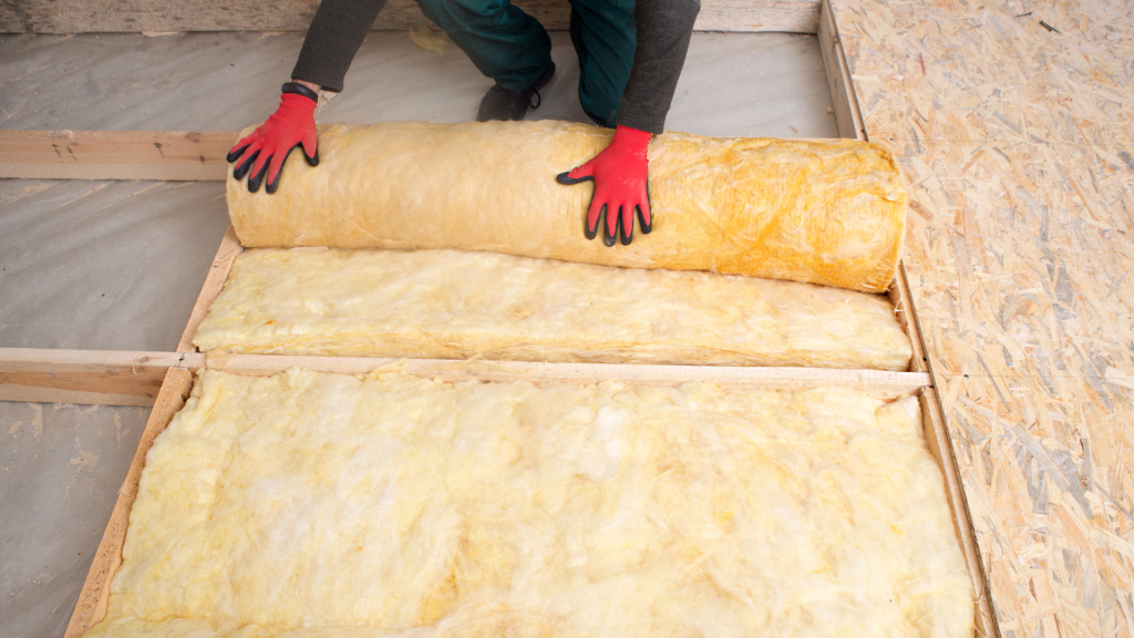 Insulation being installed in a loft