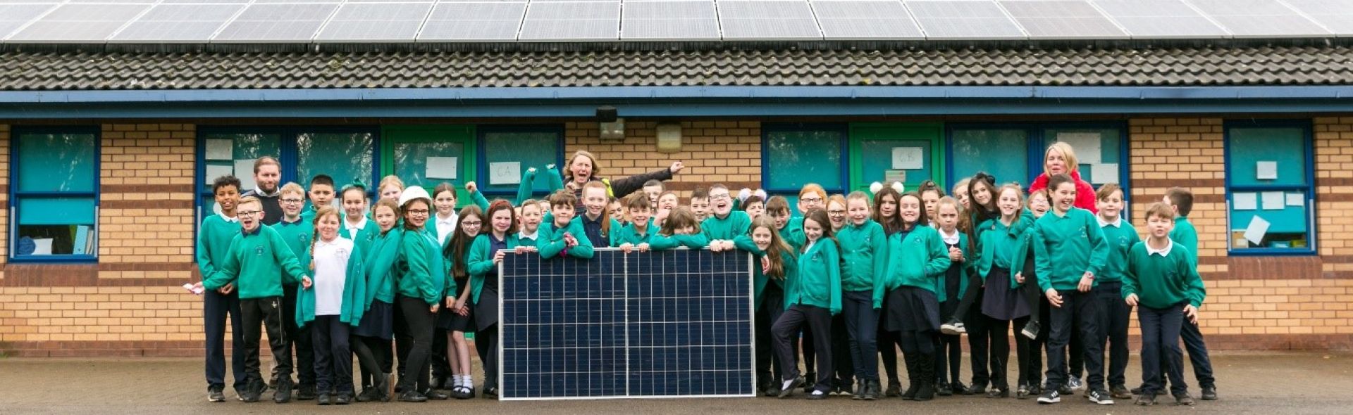 Photo of school children with solar panels