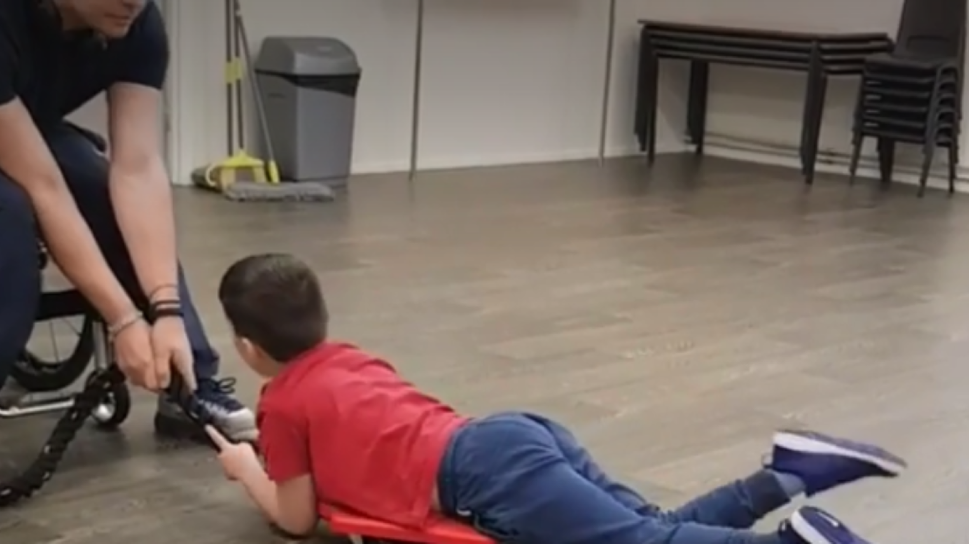 Louis encourages a young client – building core strength.(Taken as a still from video on their website)