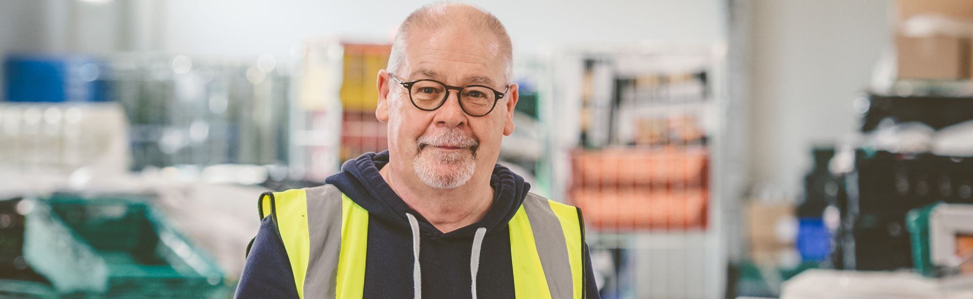 A man holding a clipboard in a warehouse
