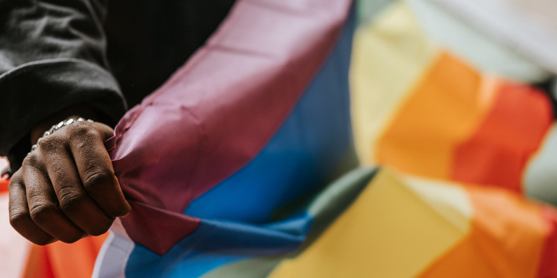 Man holding rainbow flag