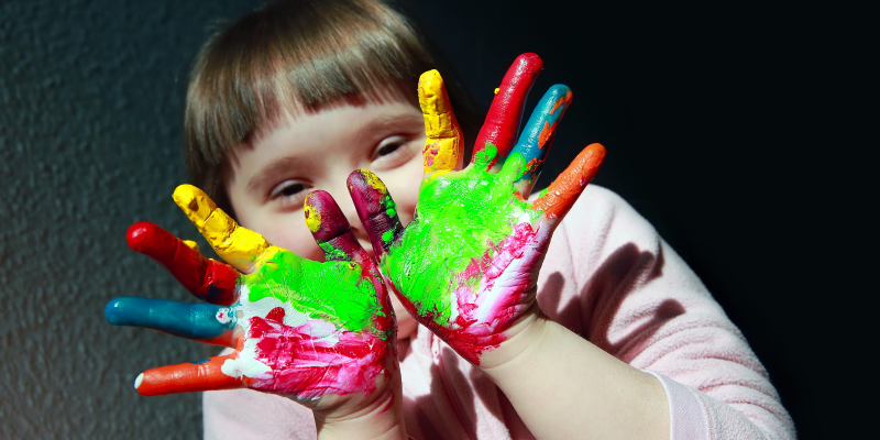 Young girl with paint on her hands