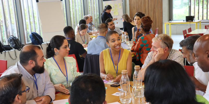 People having an engaged discussion around a table