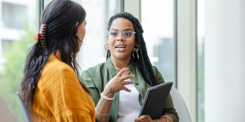 Two women discussing pre-investment support 