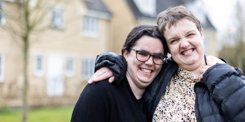 Two women stood outside a residential house