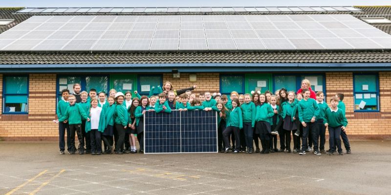 Photo of school children with solar panels