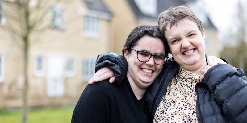 Two women stood outside a residential house