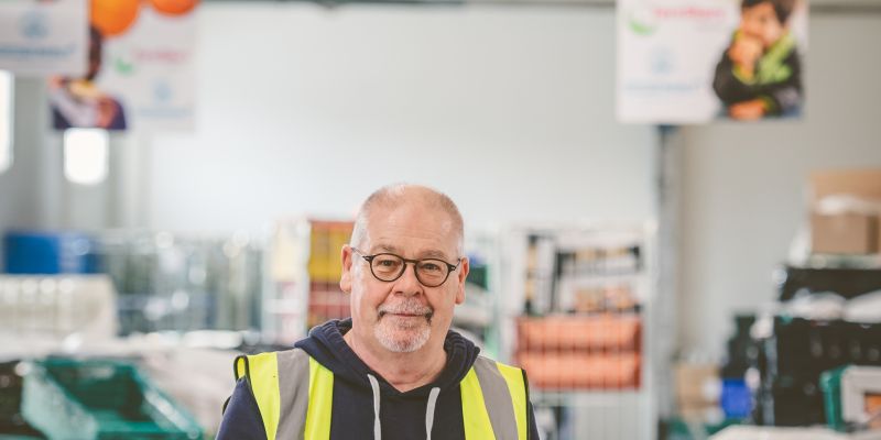 A man holding a clipboard in a warehouse