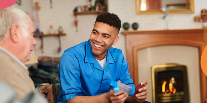 A young man smiling and talking to an older man